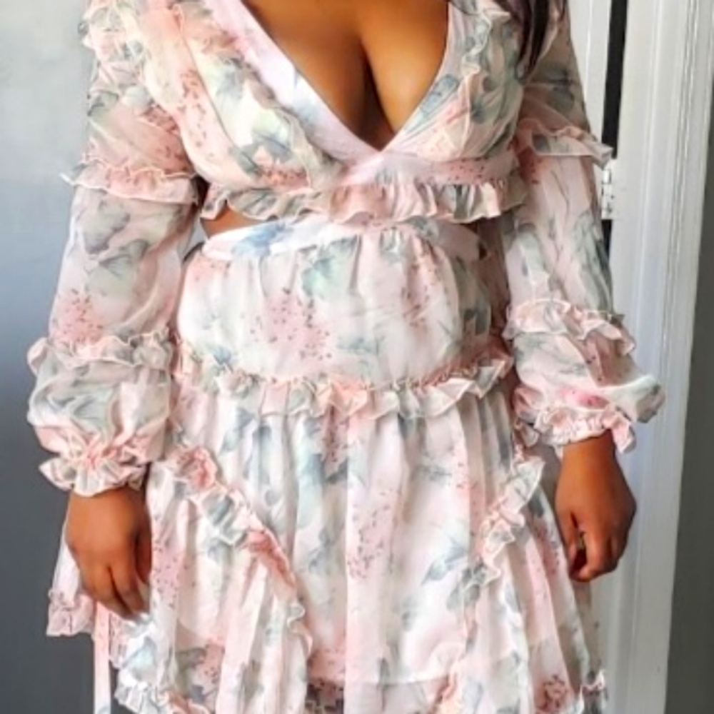 Floral dress with a V neck plunge and back out with a cross fabric.